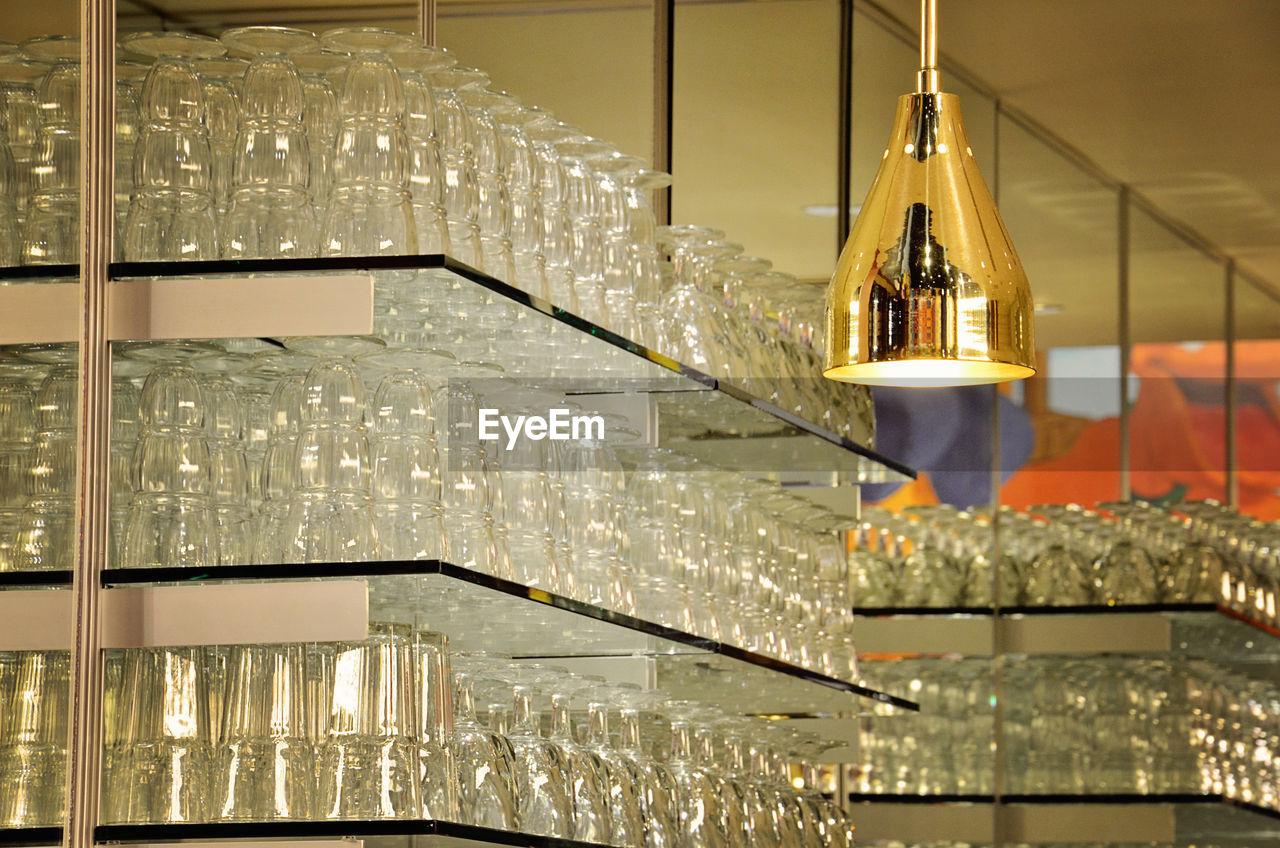 Empty sundae glasses arranged on shelves at ice cream parlor