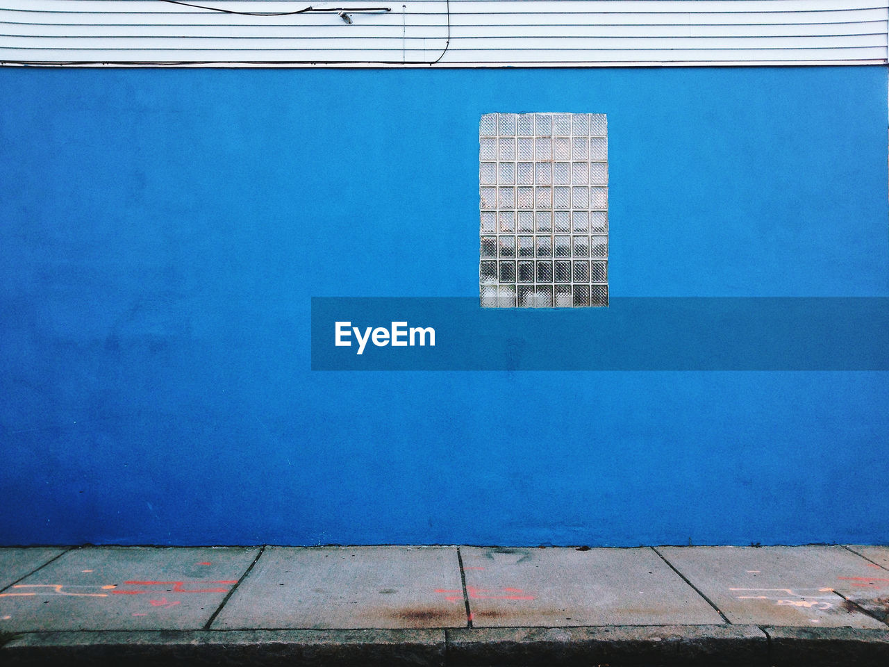 Glass window on blue wall