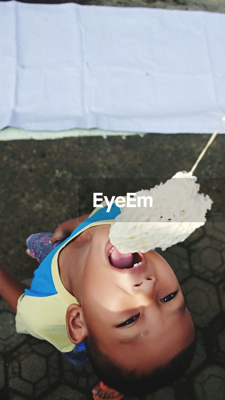 CLOSE-UP PORTRAIT OF A GIRL WITH ICE CREAM