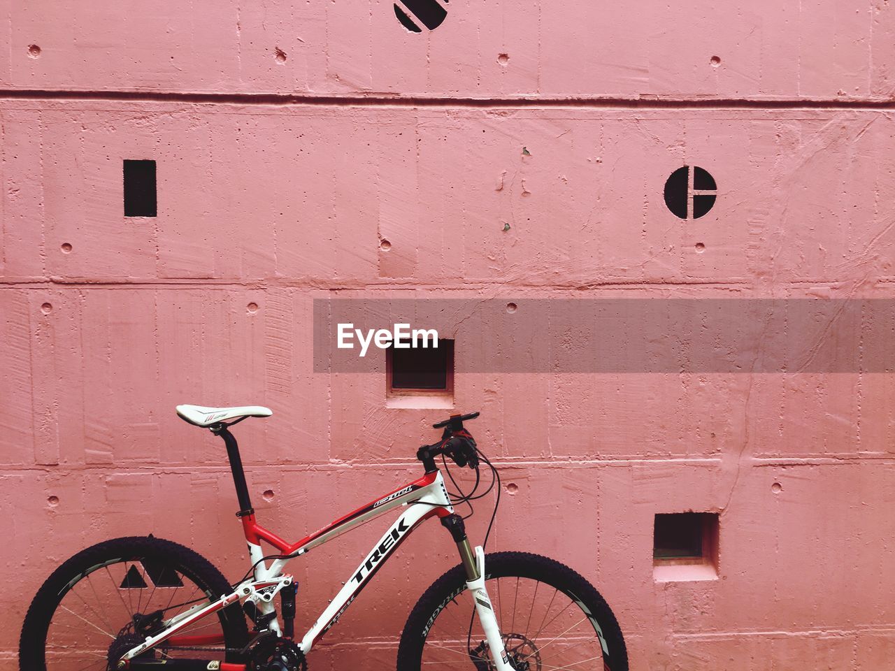 BICYCLES LEANING AGAINST WALL