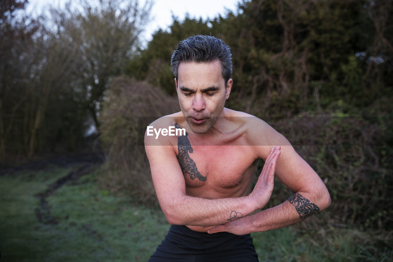 Man with eyes closed meditating in water