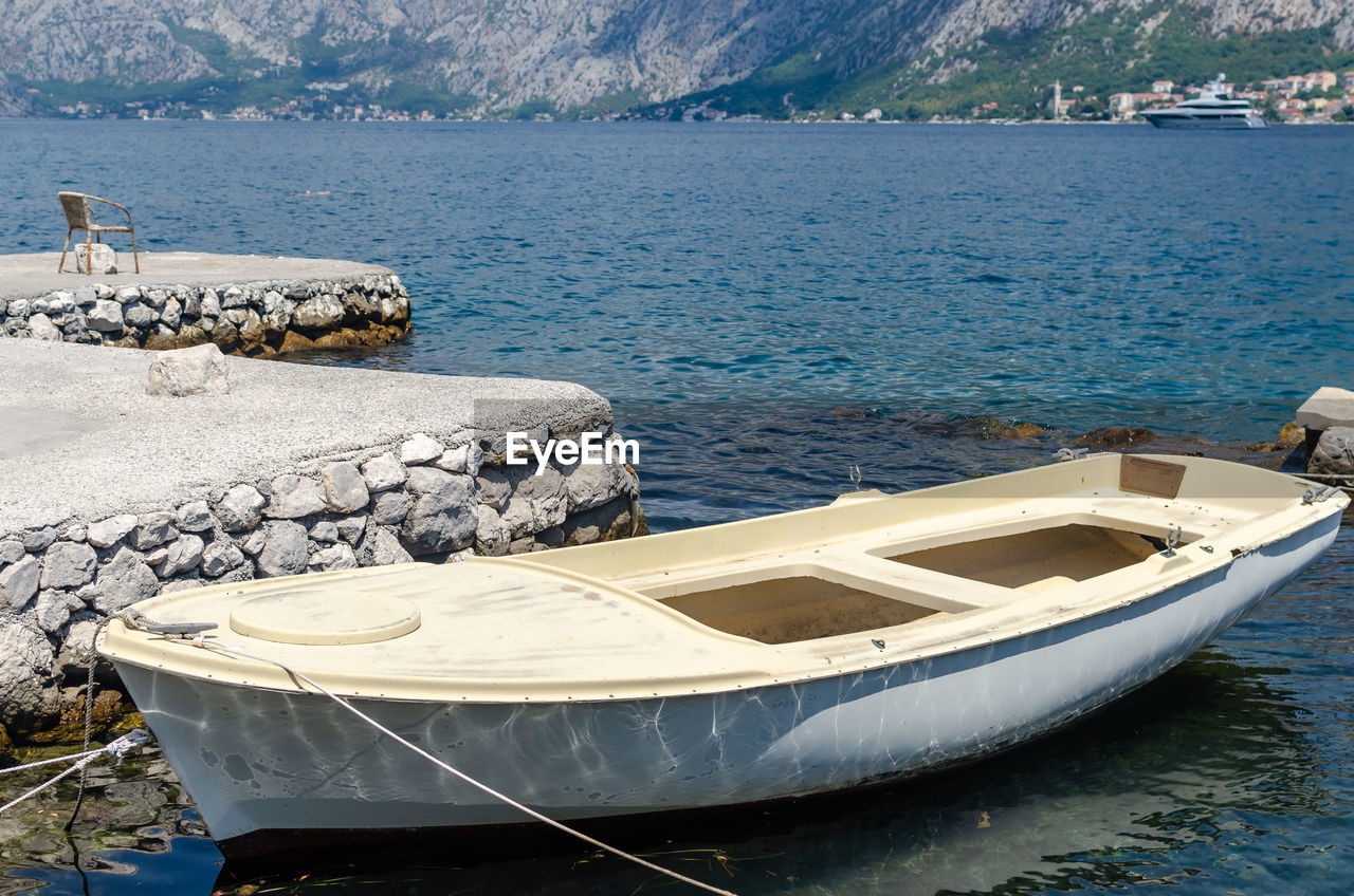 water, nautical vessel, transportation, boat, vehicle, sea, mode of transportation, nature, moored, no people, mountain, land, beach, bay, watercraft, scenics - nature, boating, day, travel, skiff, beauty in nature, tranquility, dinghy, travel destinations, ship, shore, outdoors, tranquil scene, rock, coast, architecture, environment