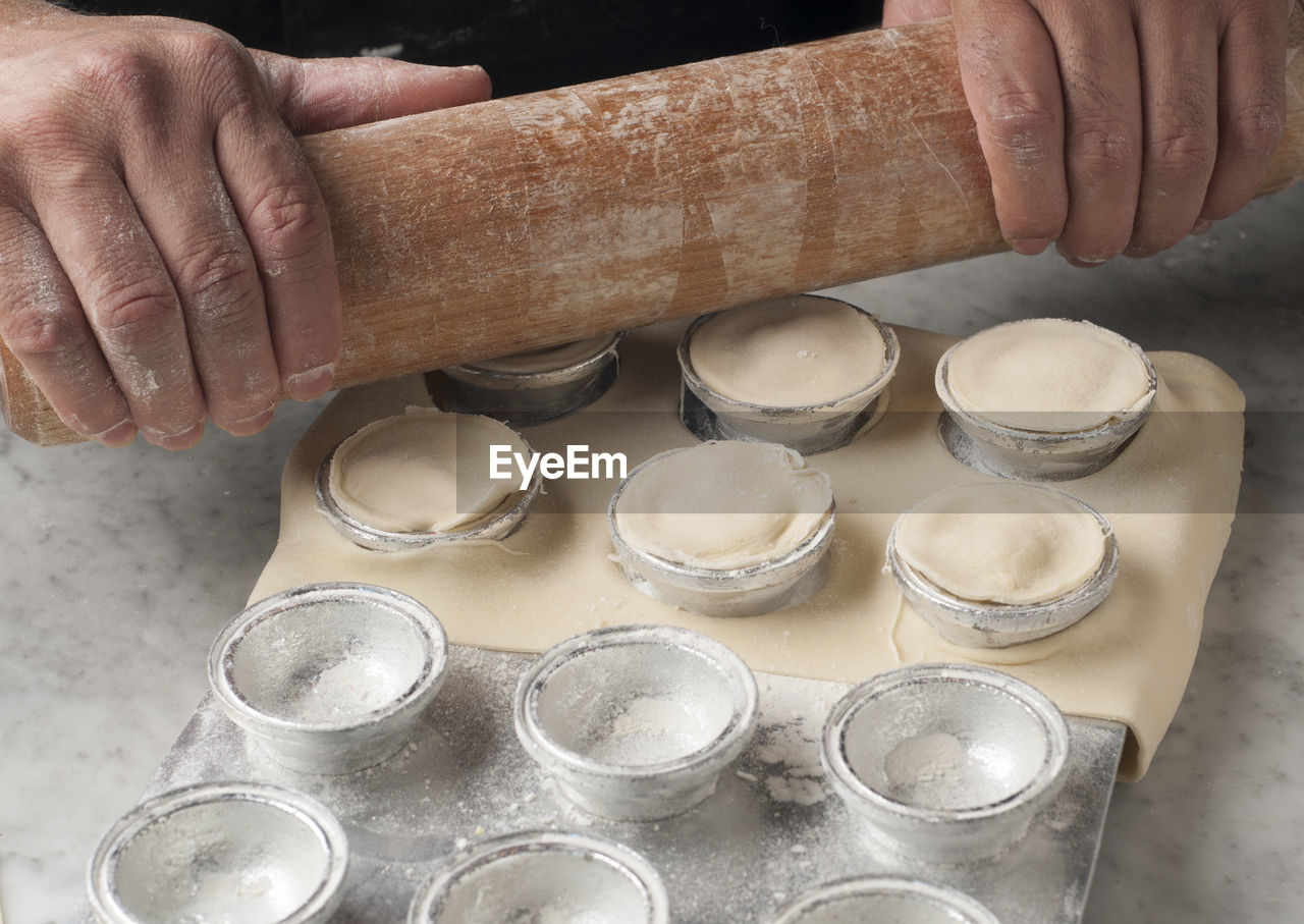 Cropped hands of chef preparing food on table in commercial kitchen