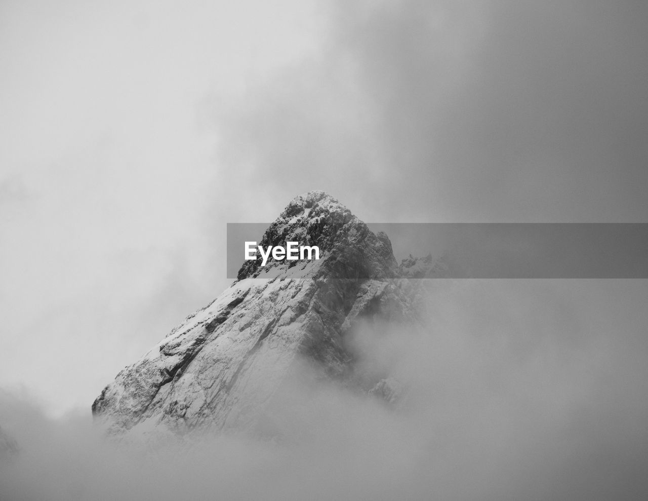 Peak of mountain between clouds