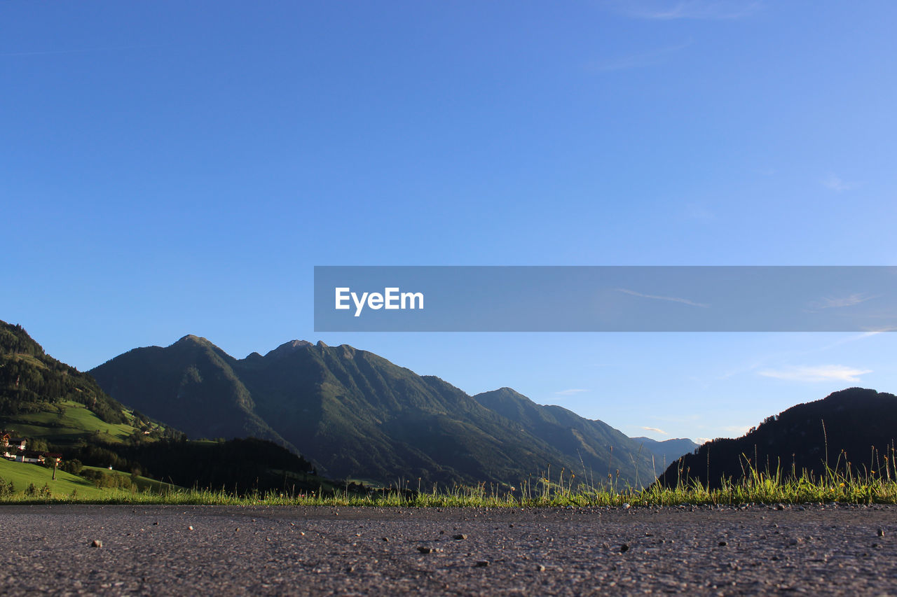 Scenic view of field against clear blue sky