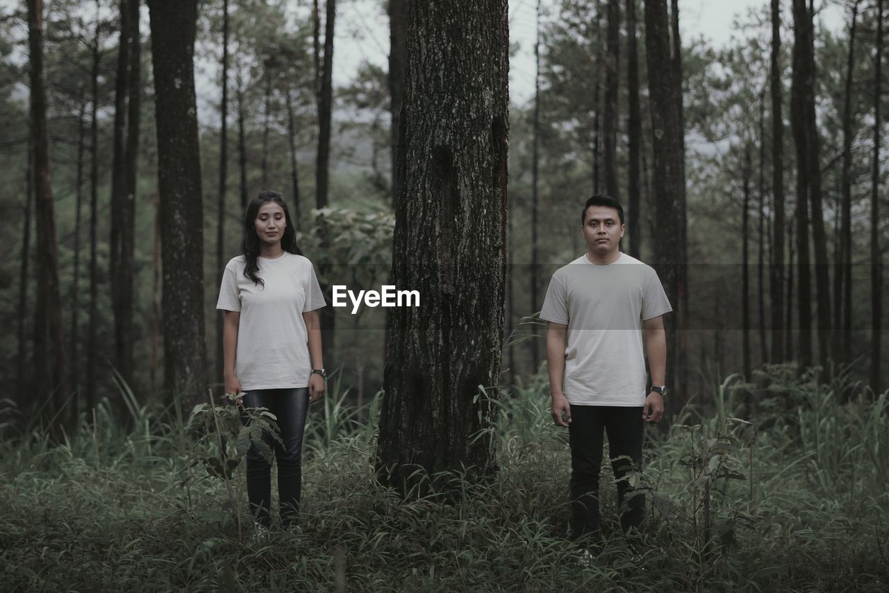 Full length of man standing on field in forest