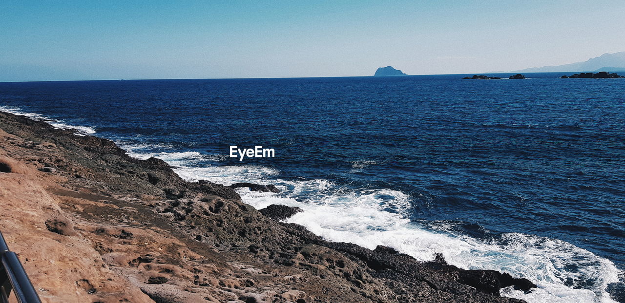 Scenic view of sea against clear sky