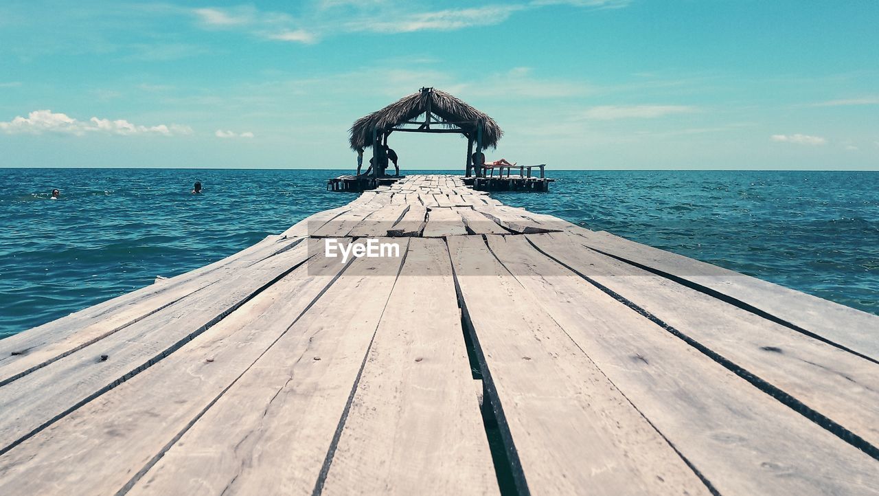 Pier over sea against sky