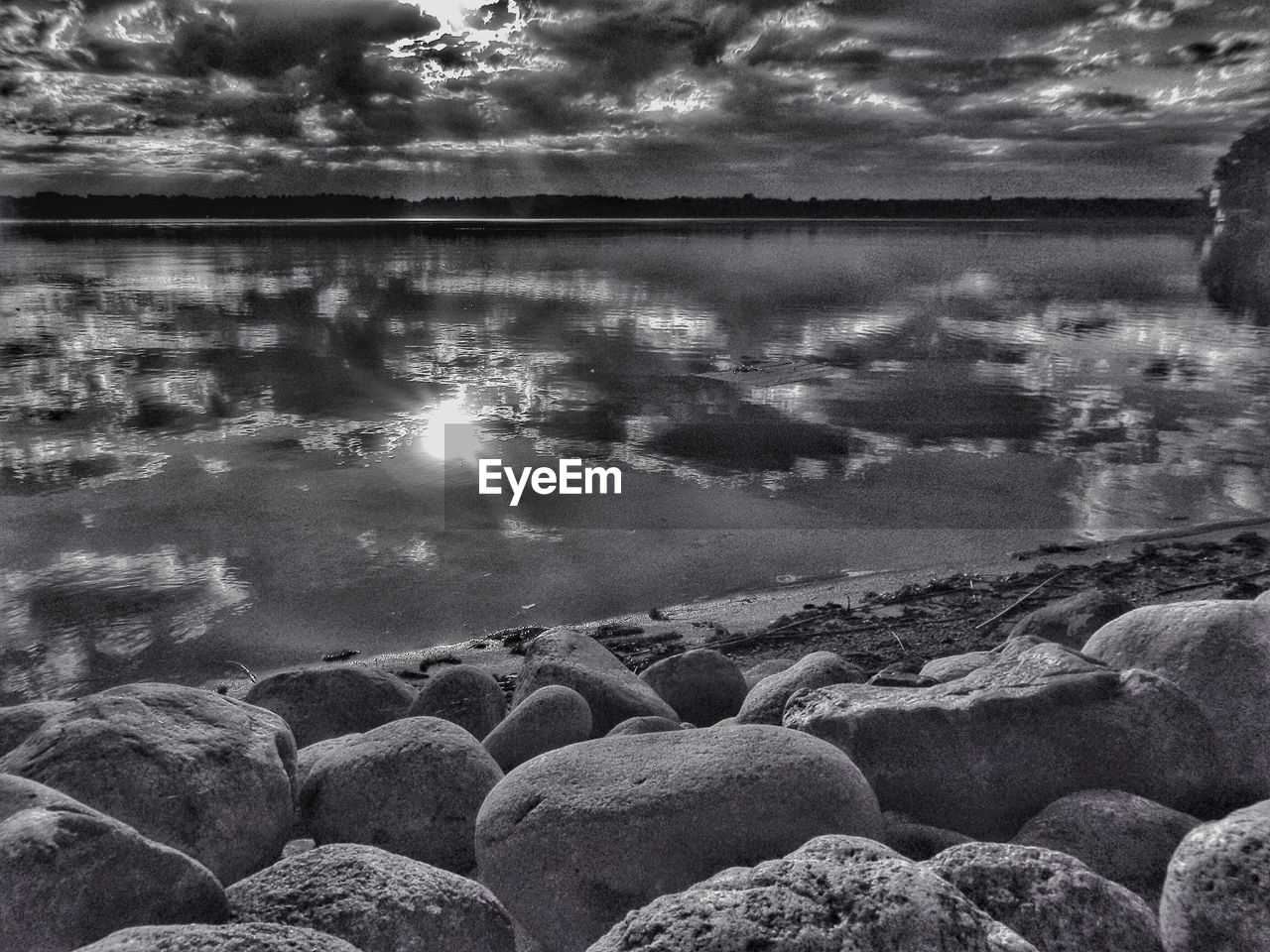 High angle view of lake against cloudy sky at dusk