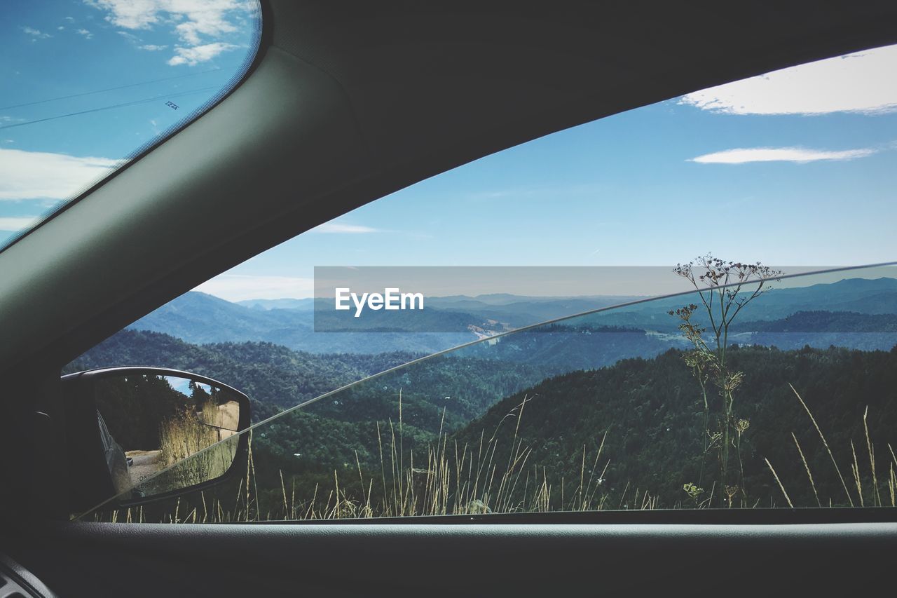 Scenic view of mountains seen through car window