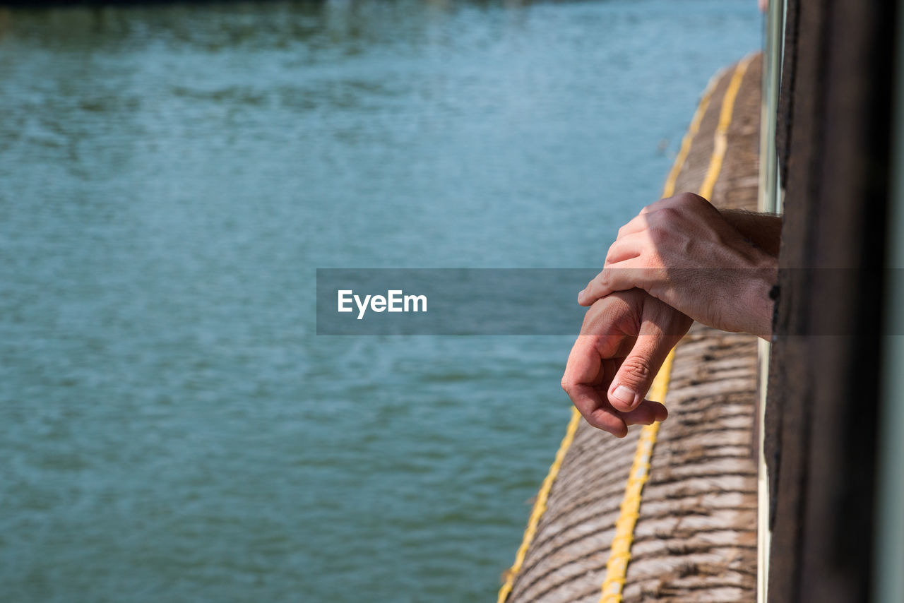 Cropped image of man by lake