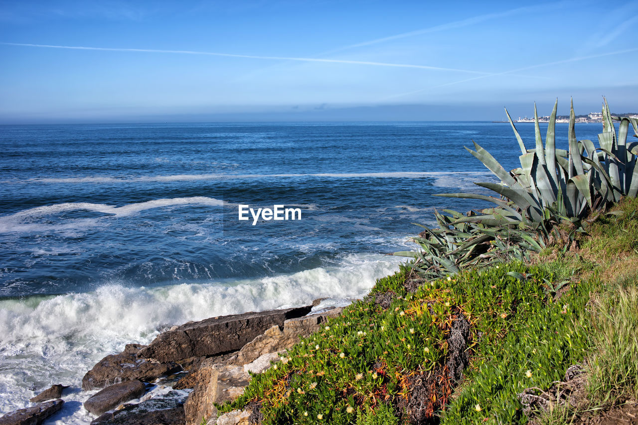 Scenic view of sea against blue sky