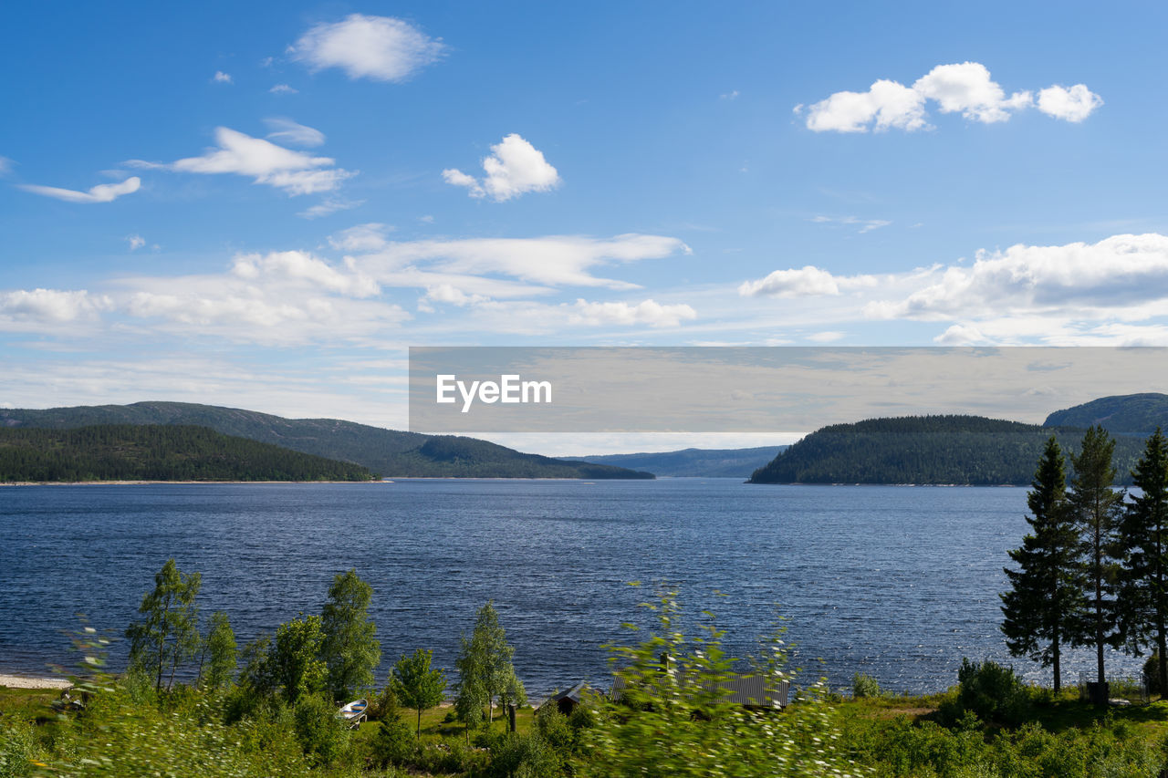 Scenic view of lake and mountains against sky