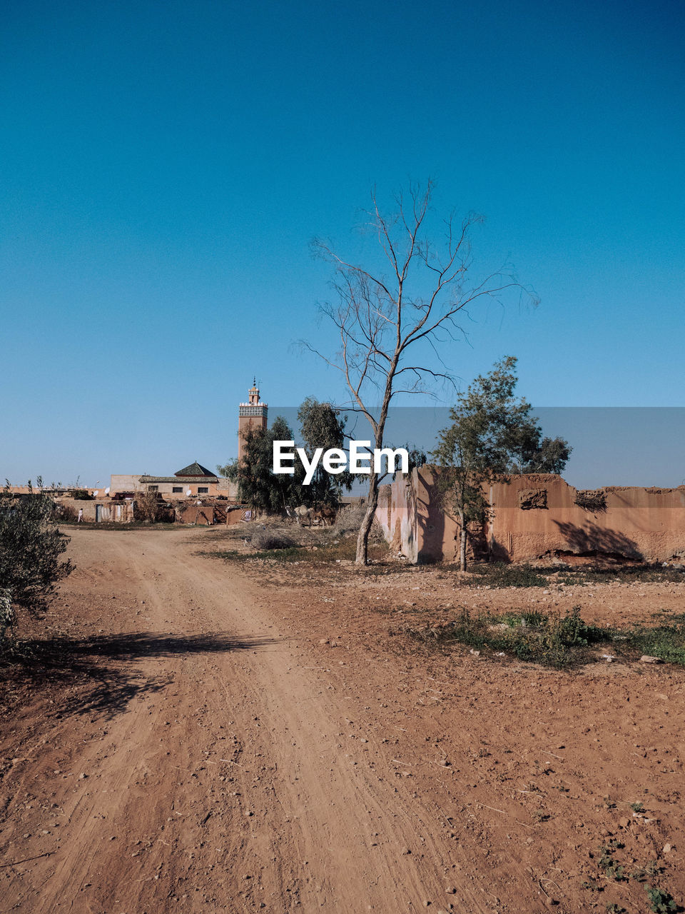 Scenic view of desert against clear blue sky