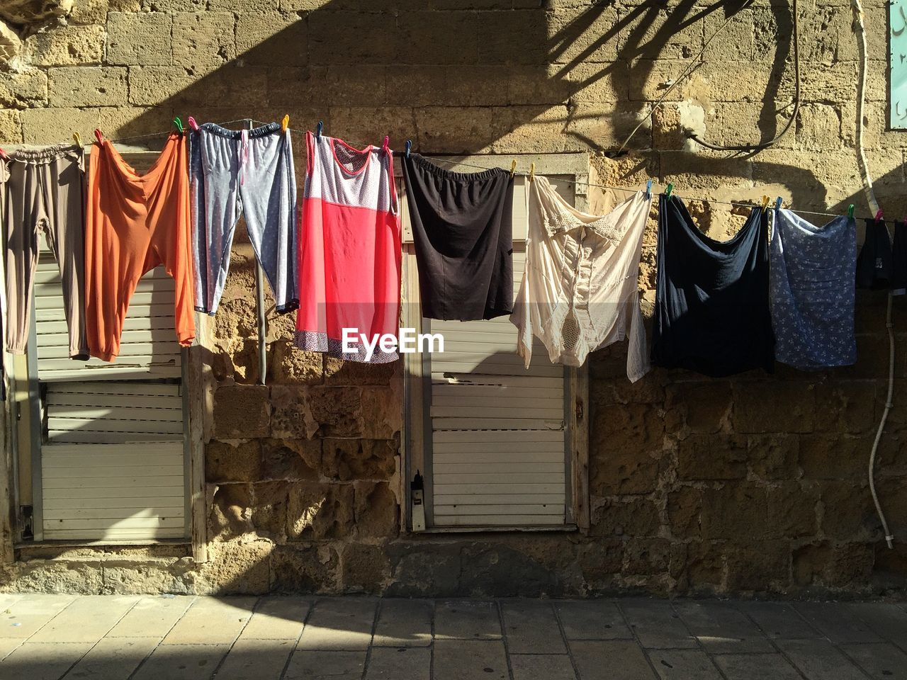 Close-up of clothes hanging on street