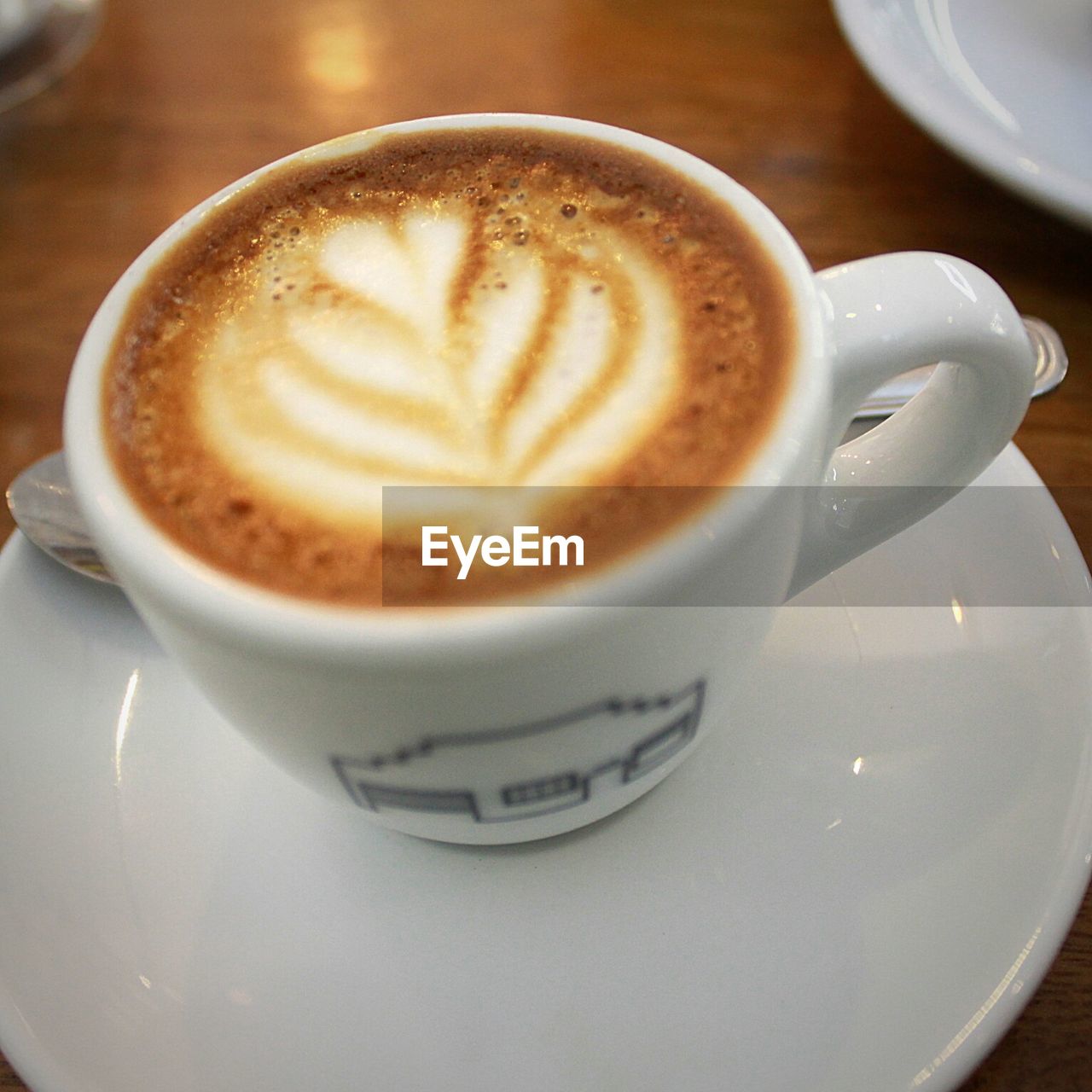 High angle view of cappuccino in cup on table