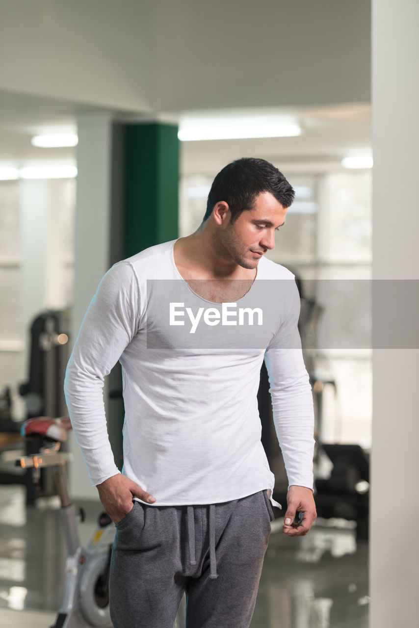 Muscular man standing in gym