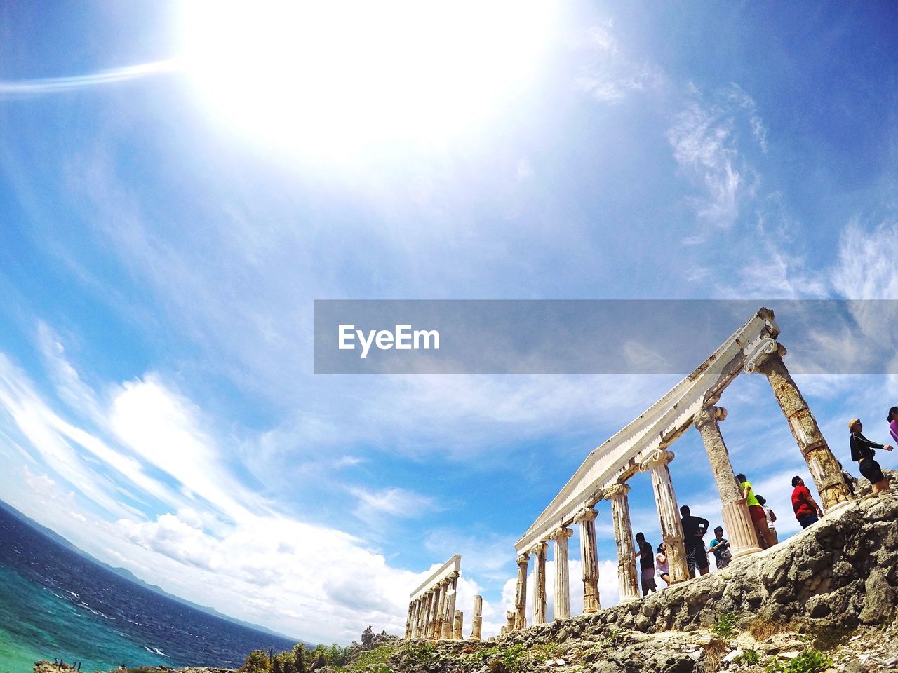 Low angle view of old ruins against sky during sunny day