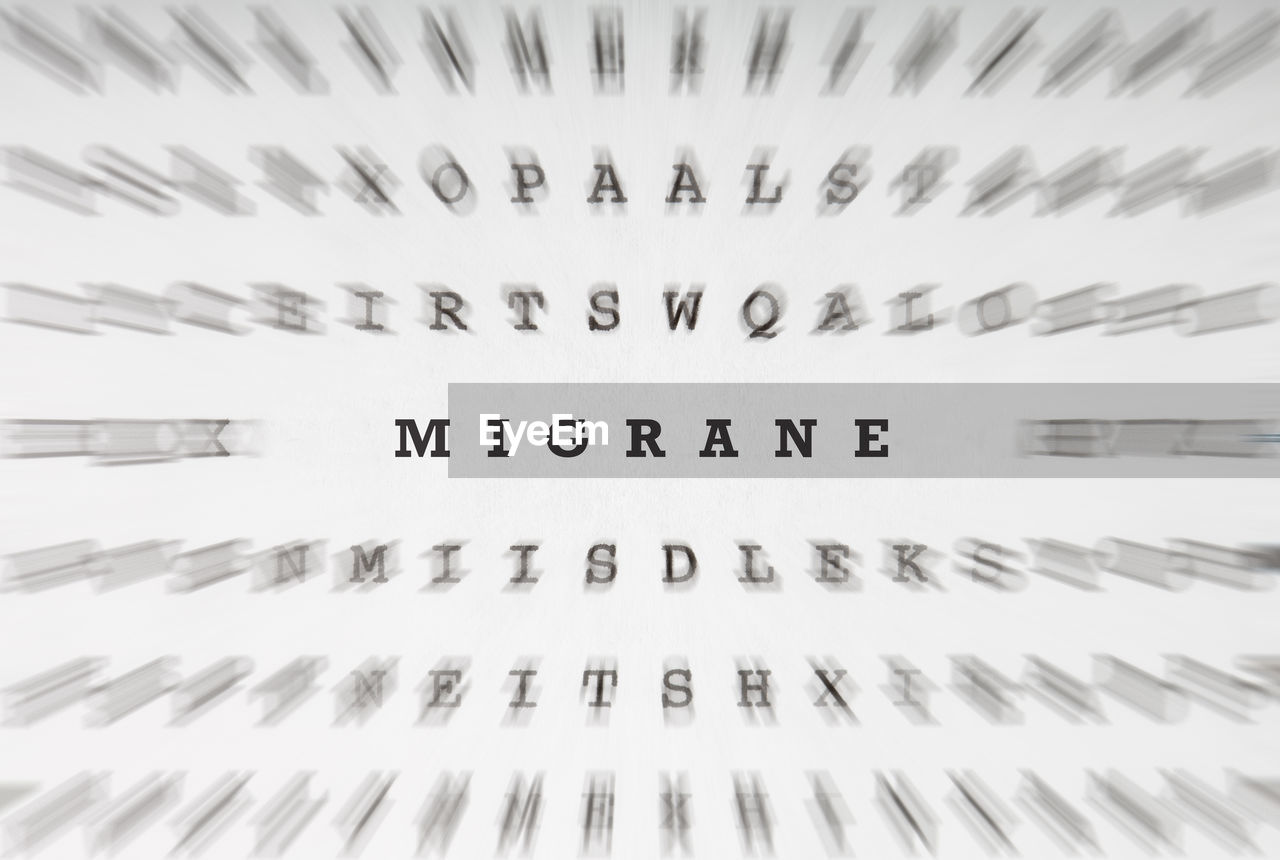 Word migrane in a puzzle or cross word riddle letter grid, focus motion blur effect 