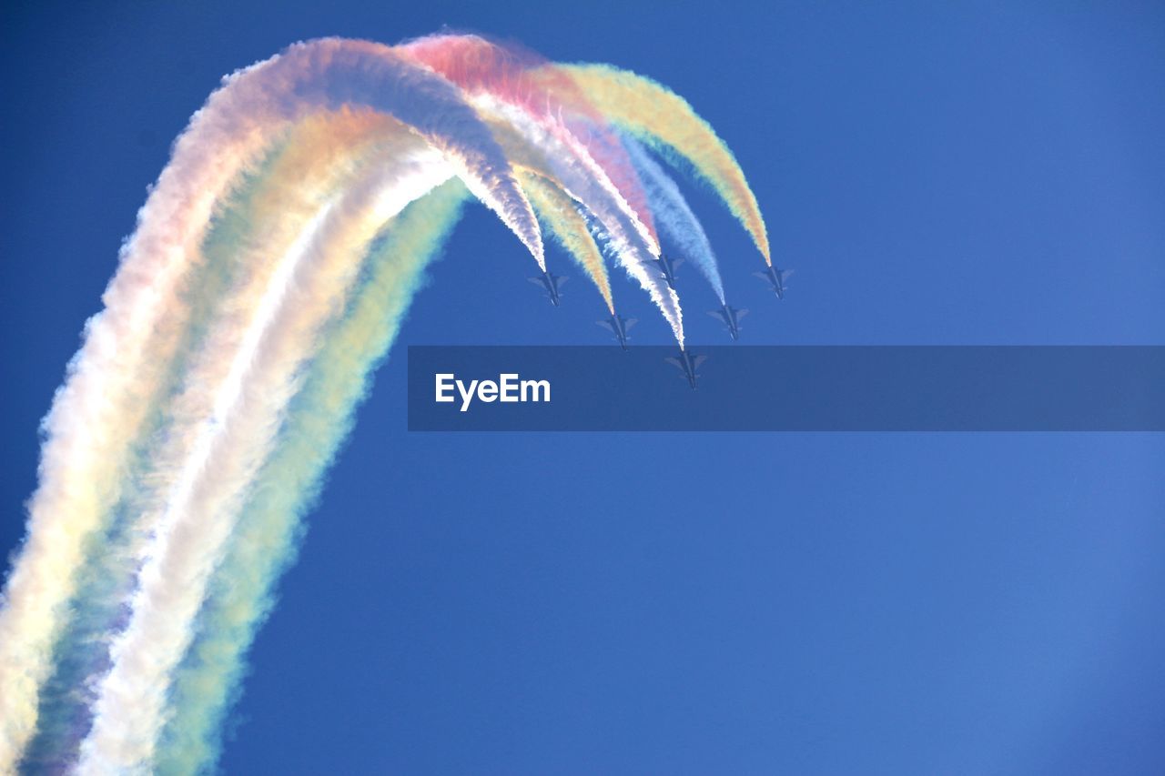 Close-up of vapor trails against blue sky