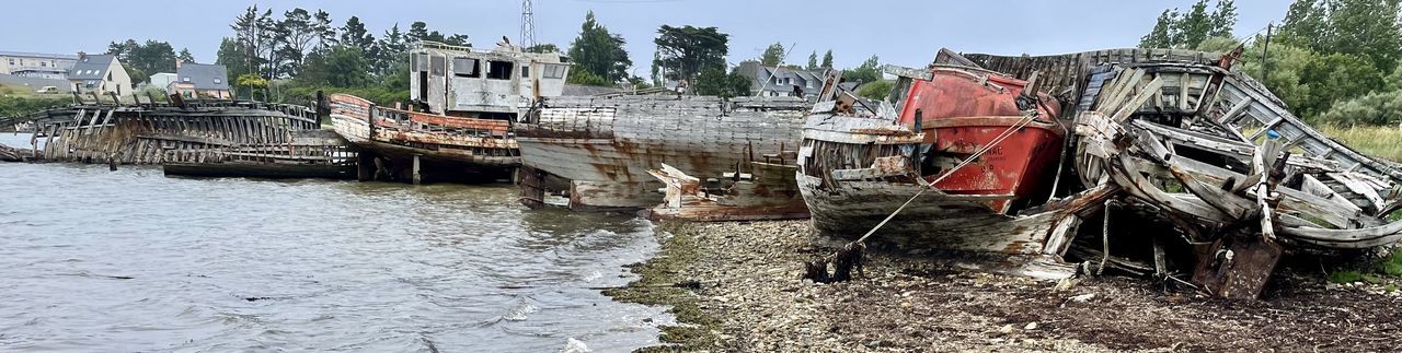 water, transportation, nautical vessel, waterway, nature, vehicle, mode of transportation, sky, architecture, no people, day, river, boat, outdoors, built structure, plant, fishing, tree, wood, landscape, damaged, environment, history, land, watercraft