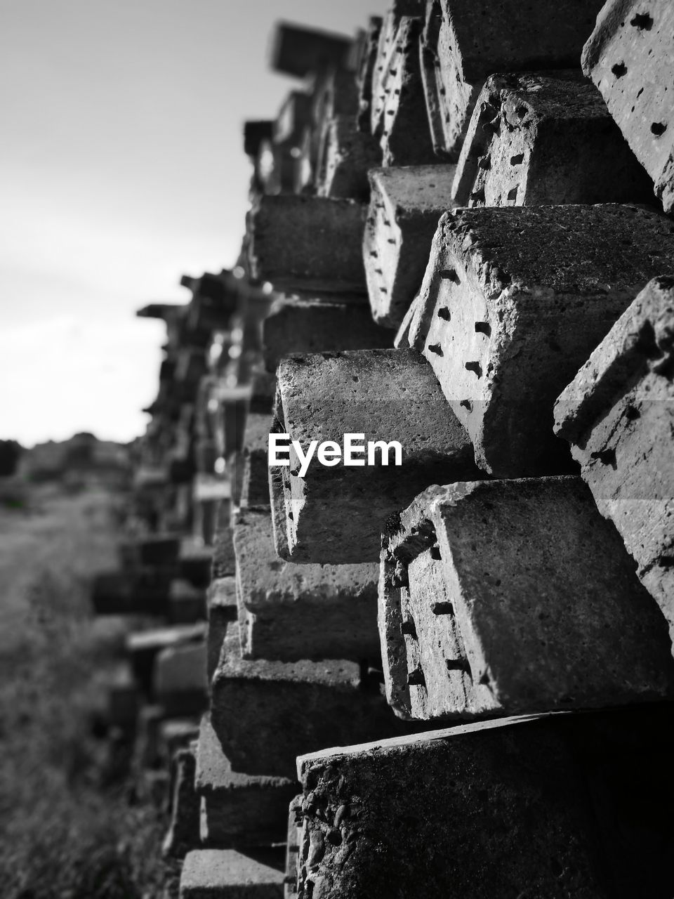 Close-up of abandoned stack against sky