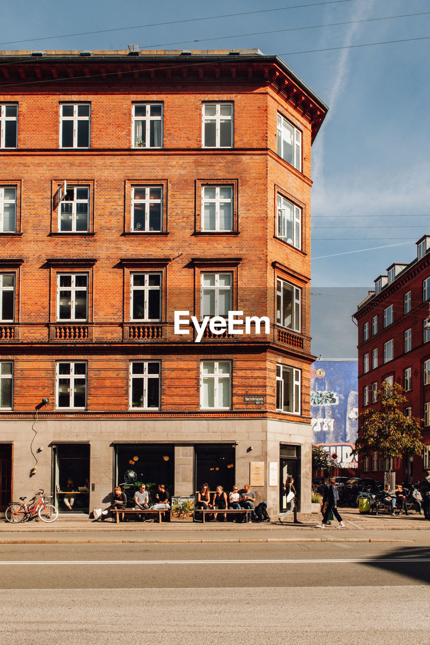 People on street amidst buildings in city