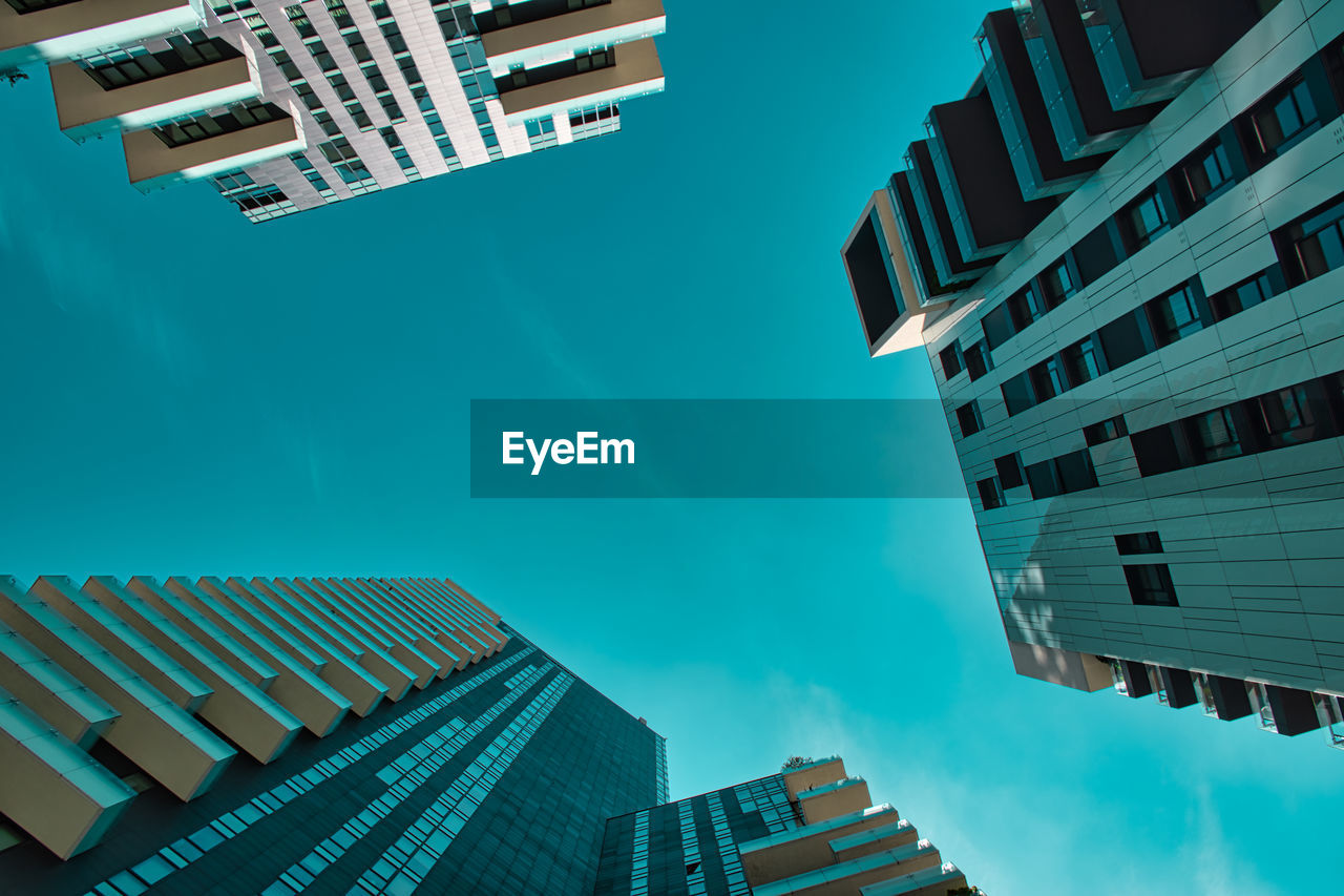 LOW ANGLE VIEW OF MODERN BUILDINGS AGAINST SKY