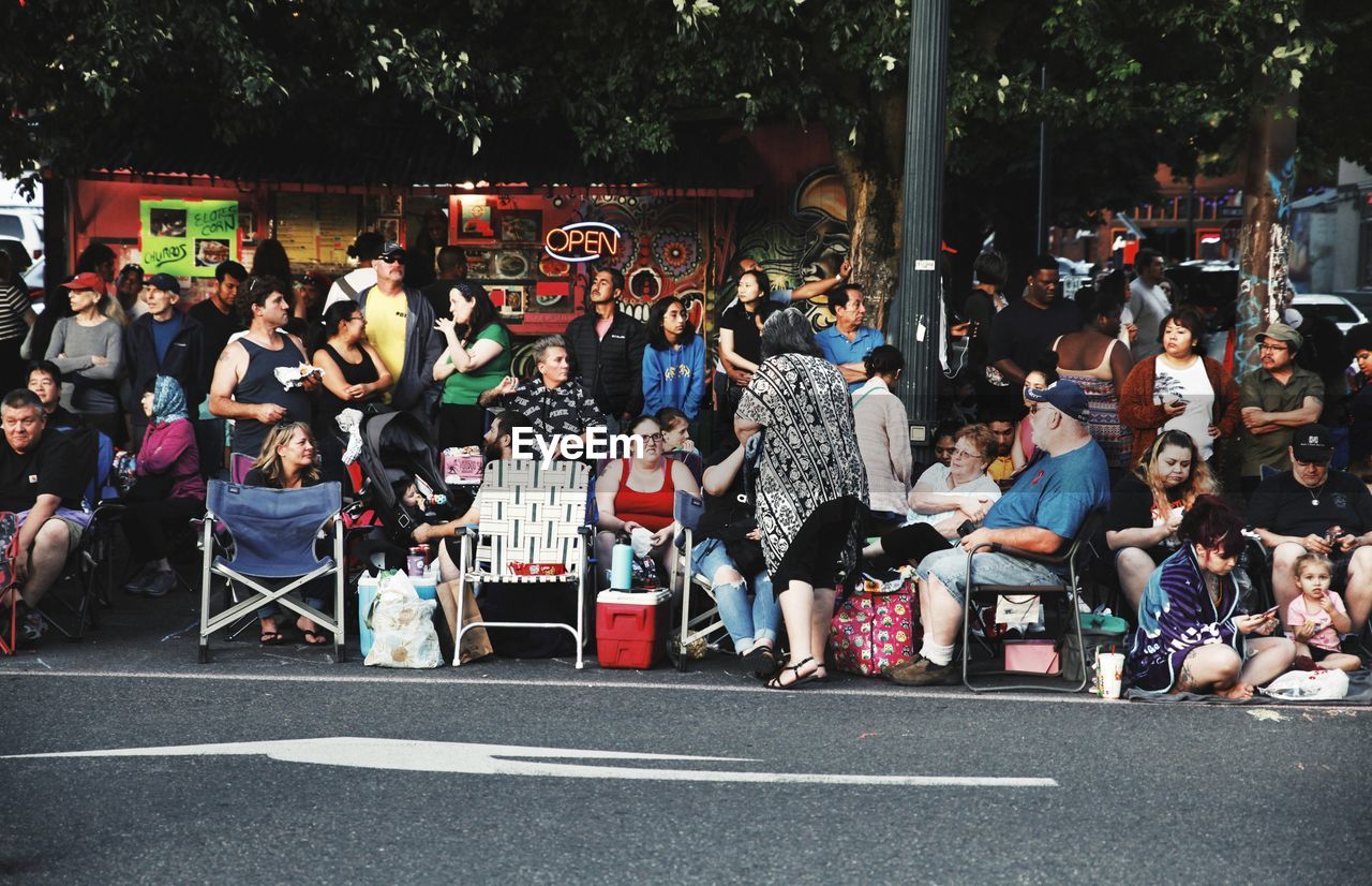 GROUP OF PEOPLE ON STREET IN CITY