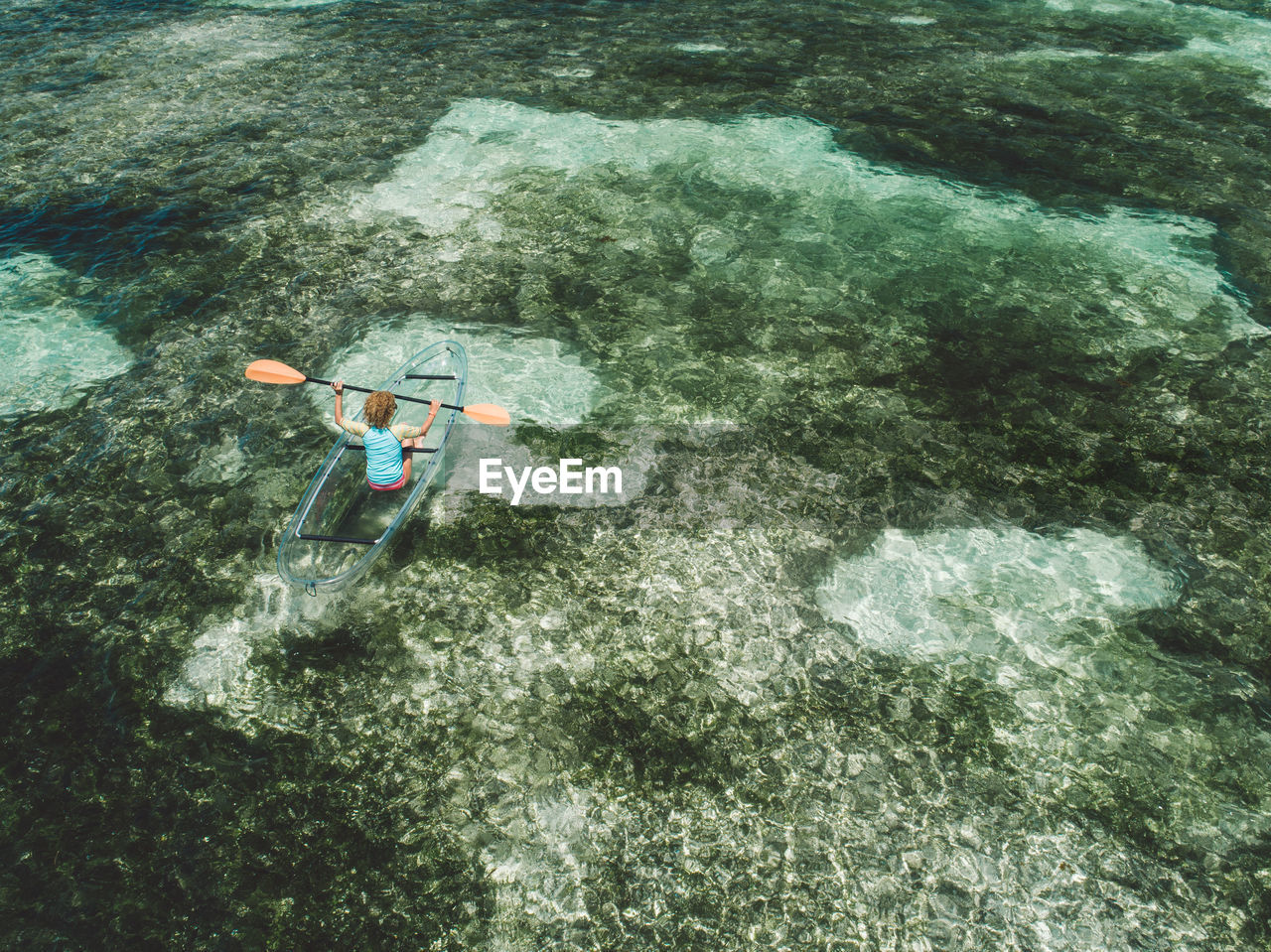 High angle view of woman on inflatable boat in sea