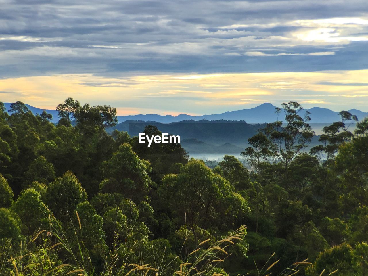 Scenic view of mountains against cloudy sky