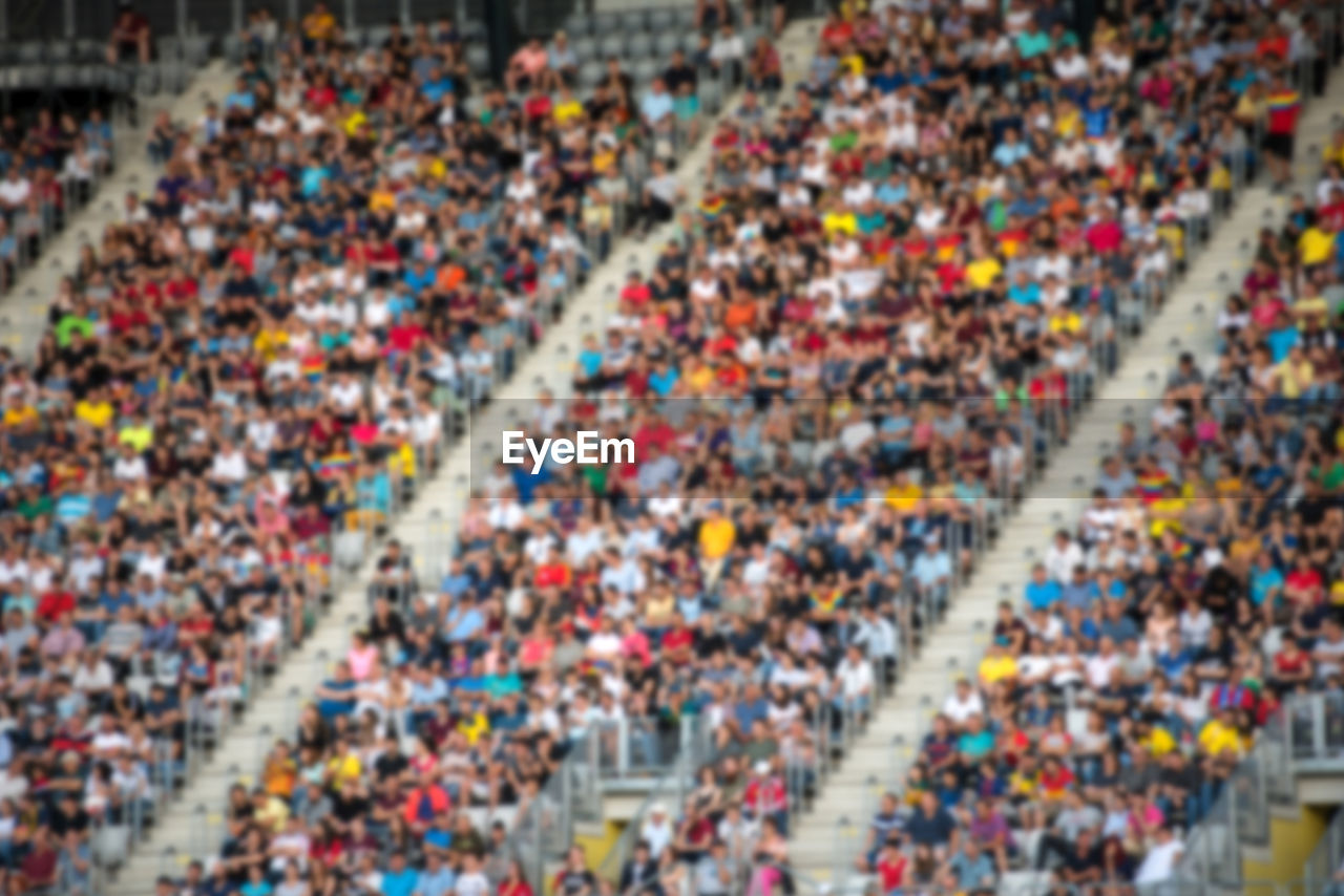 Defocused image of people sitting in stadium