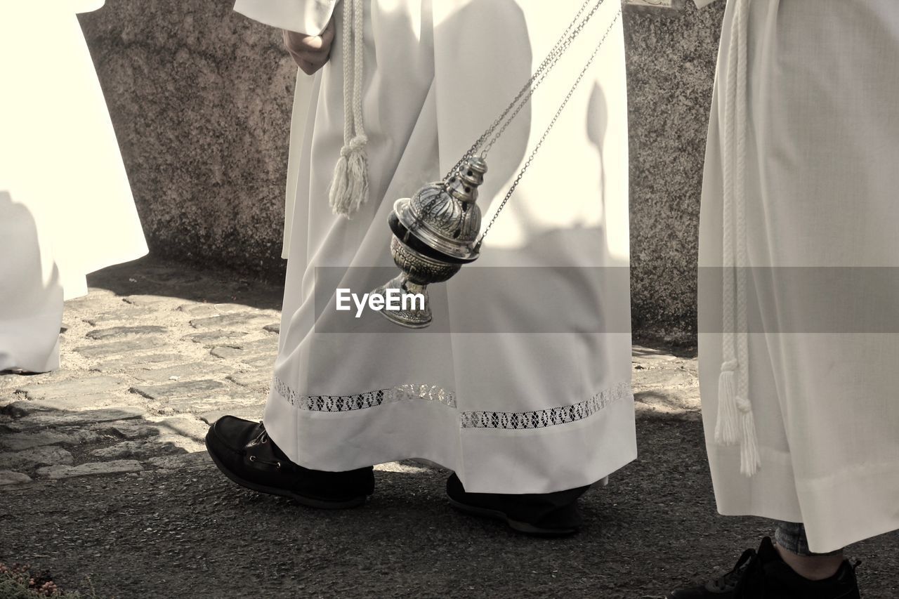 Low section of  catolic priest in a procession 