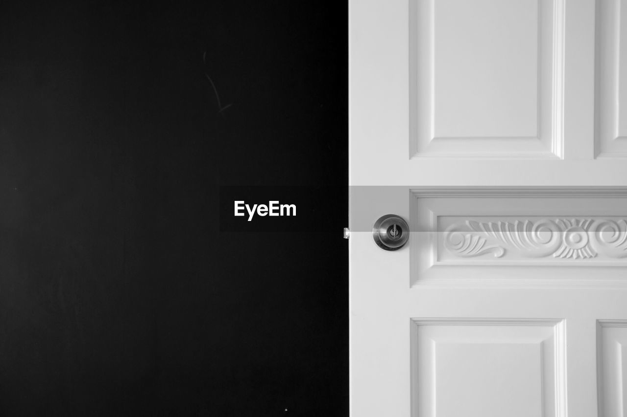 Close-up of door knob on white door