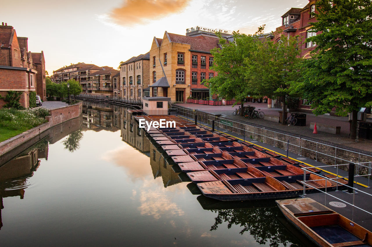 Canal amidst buildings in city against sky