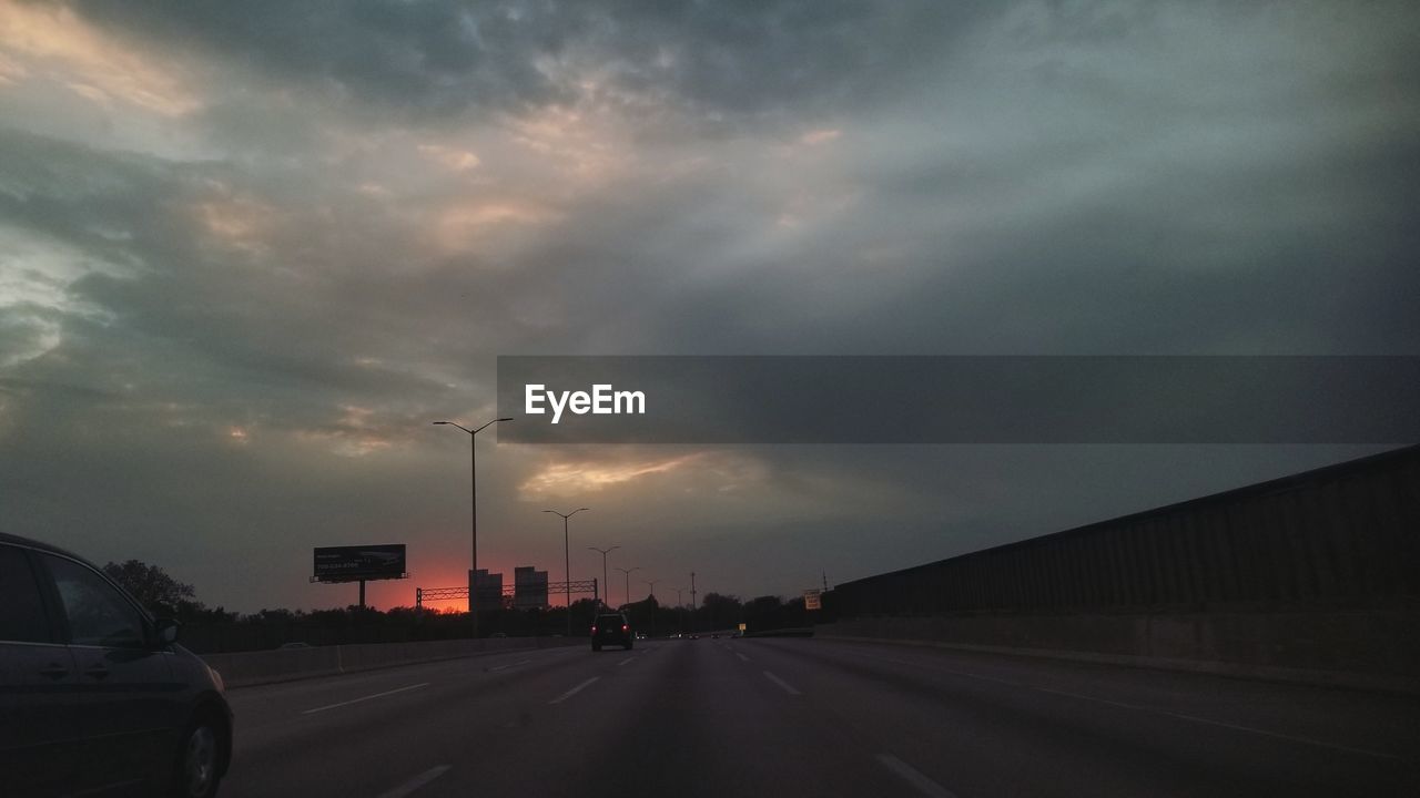 CARS ON ROAD AT SUNSET