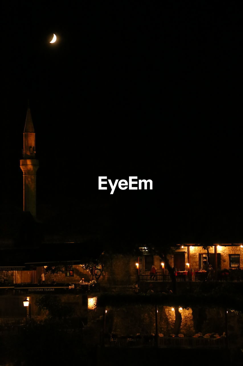 VIEW OF ILLUMINATED BUILDINGS AT NIGHT