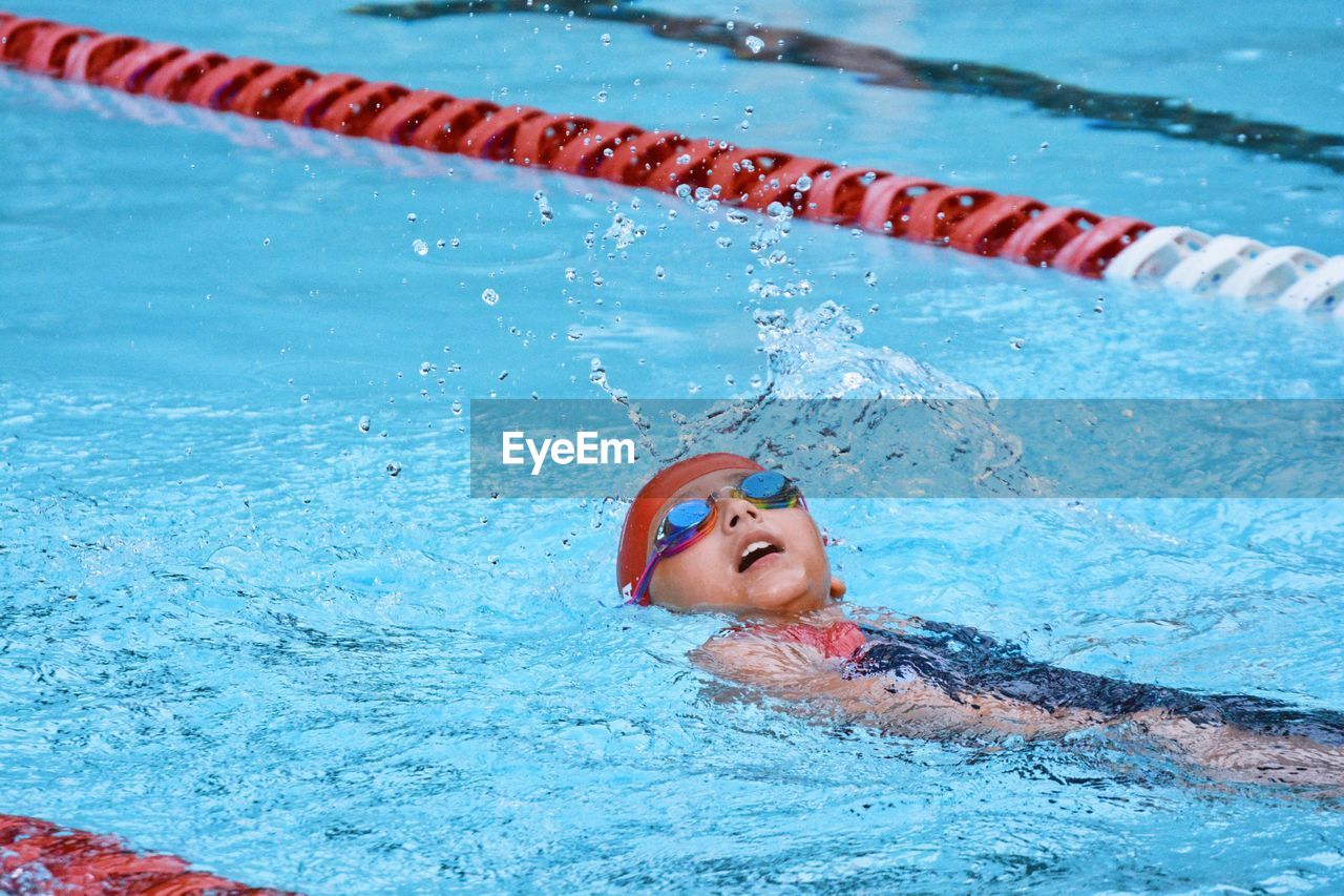 Cute boy swimming at pool