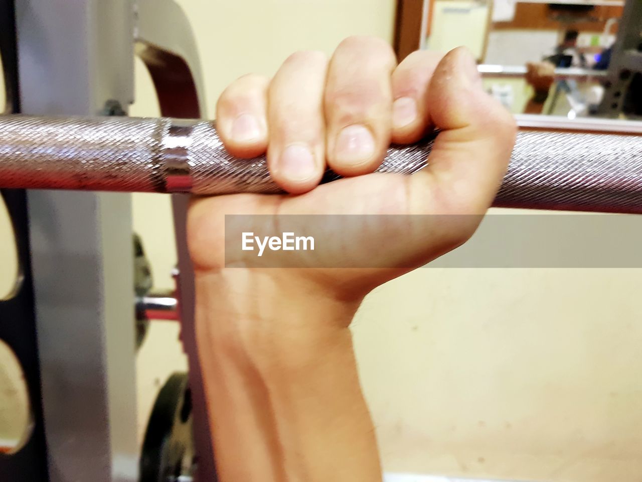 CLOSE-UP OF HANDS HOLDING METAL