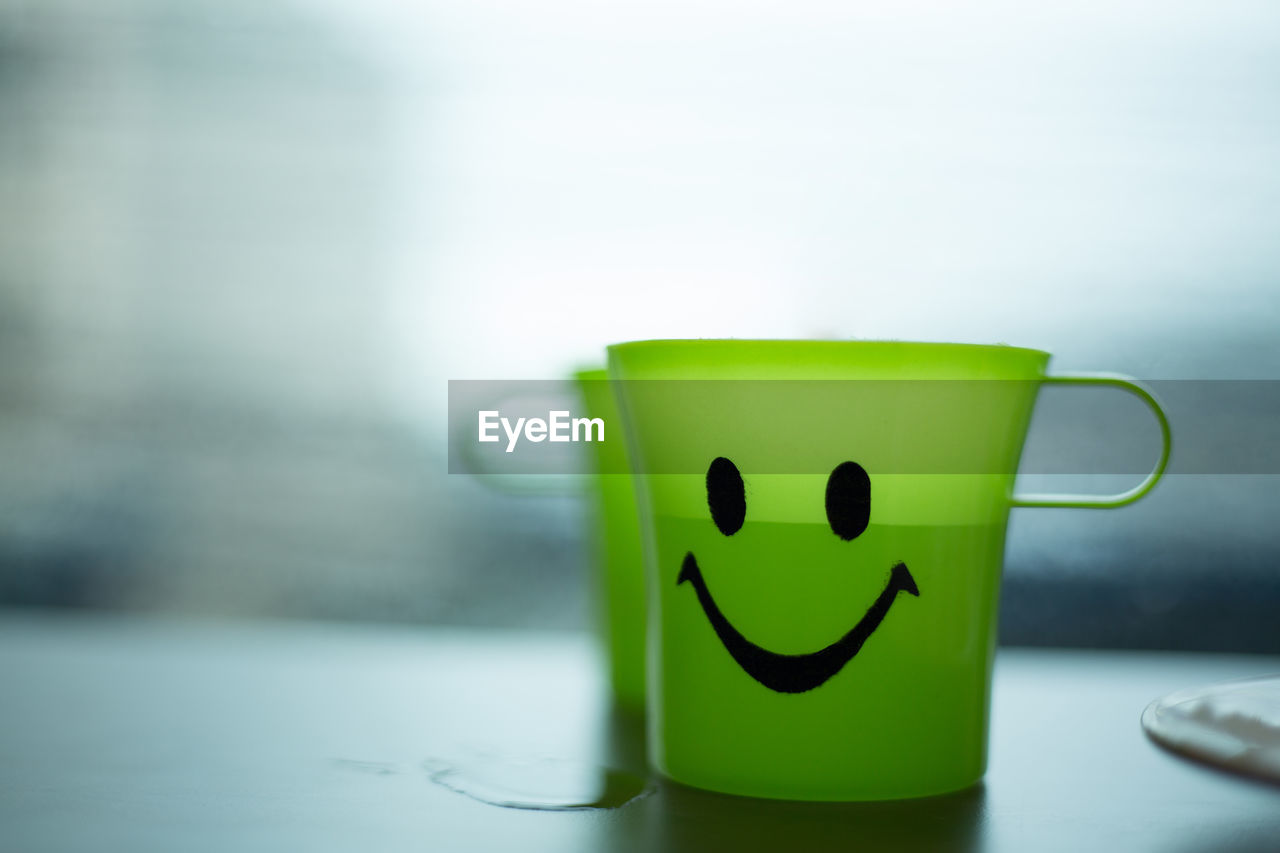 CLOSE-UP OF SMILEY FACE ON TABLE