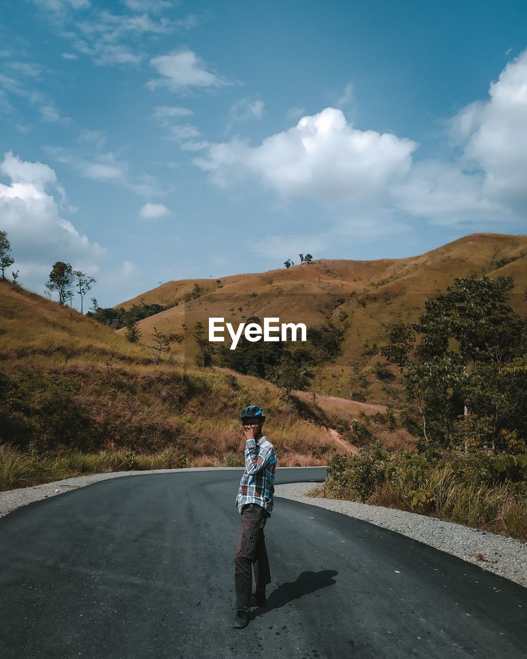 Men walking on road against sky