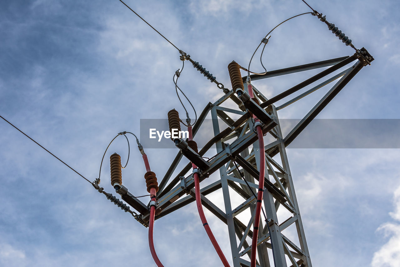 Low angle view of electricity pylon against sky