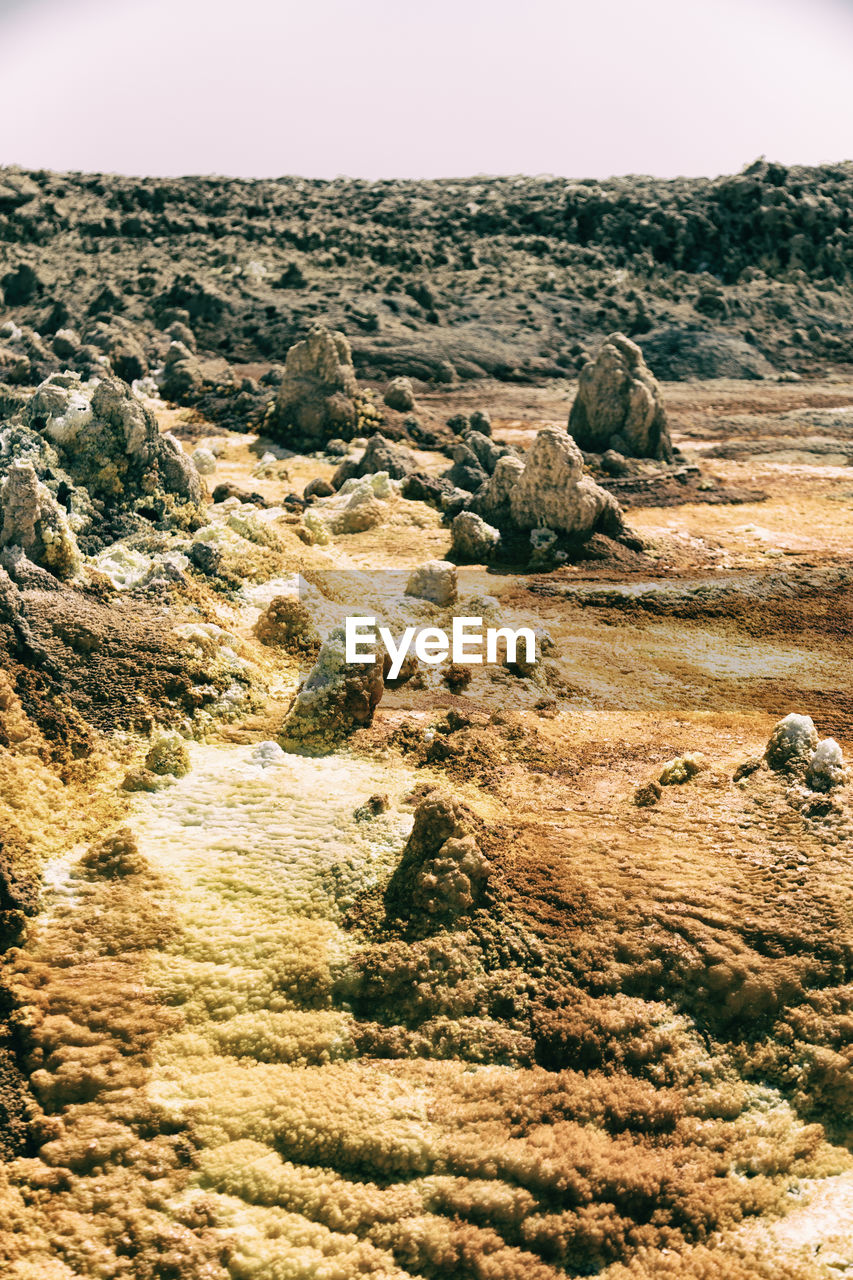 SCENIC VIEW OF ROCKS AGAINST SKY