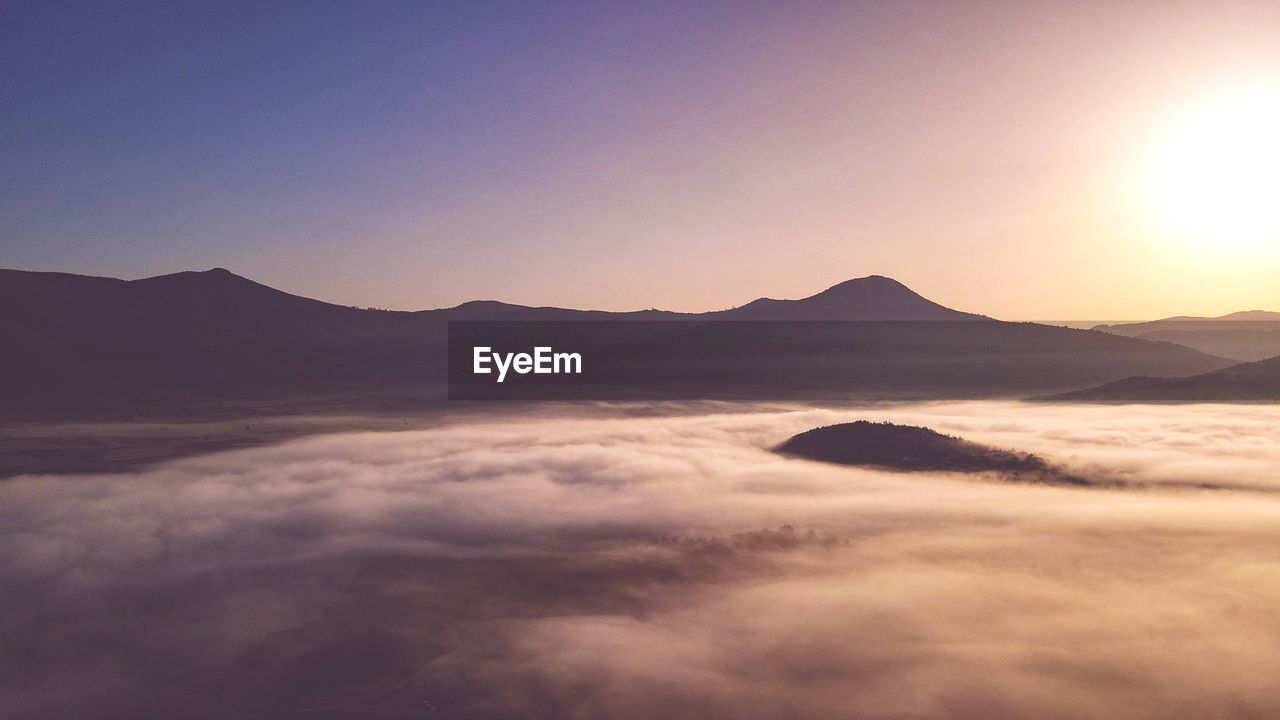 Scenic view of mountains against sky during sunset