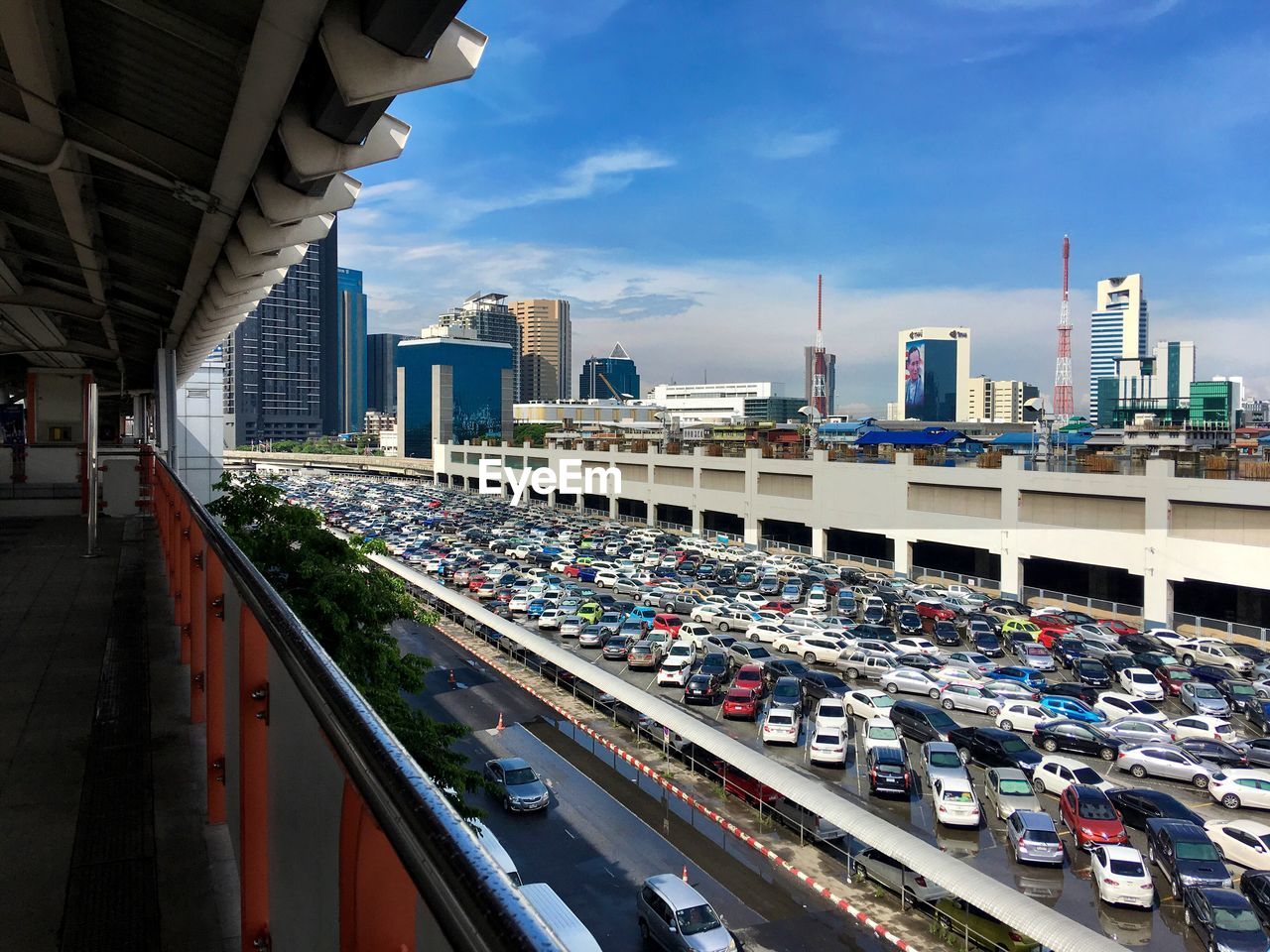 High angle view of cars at parking lot in city against sky