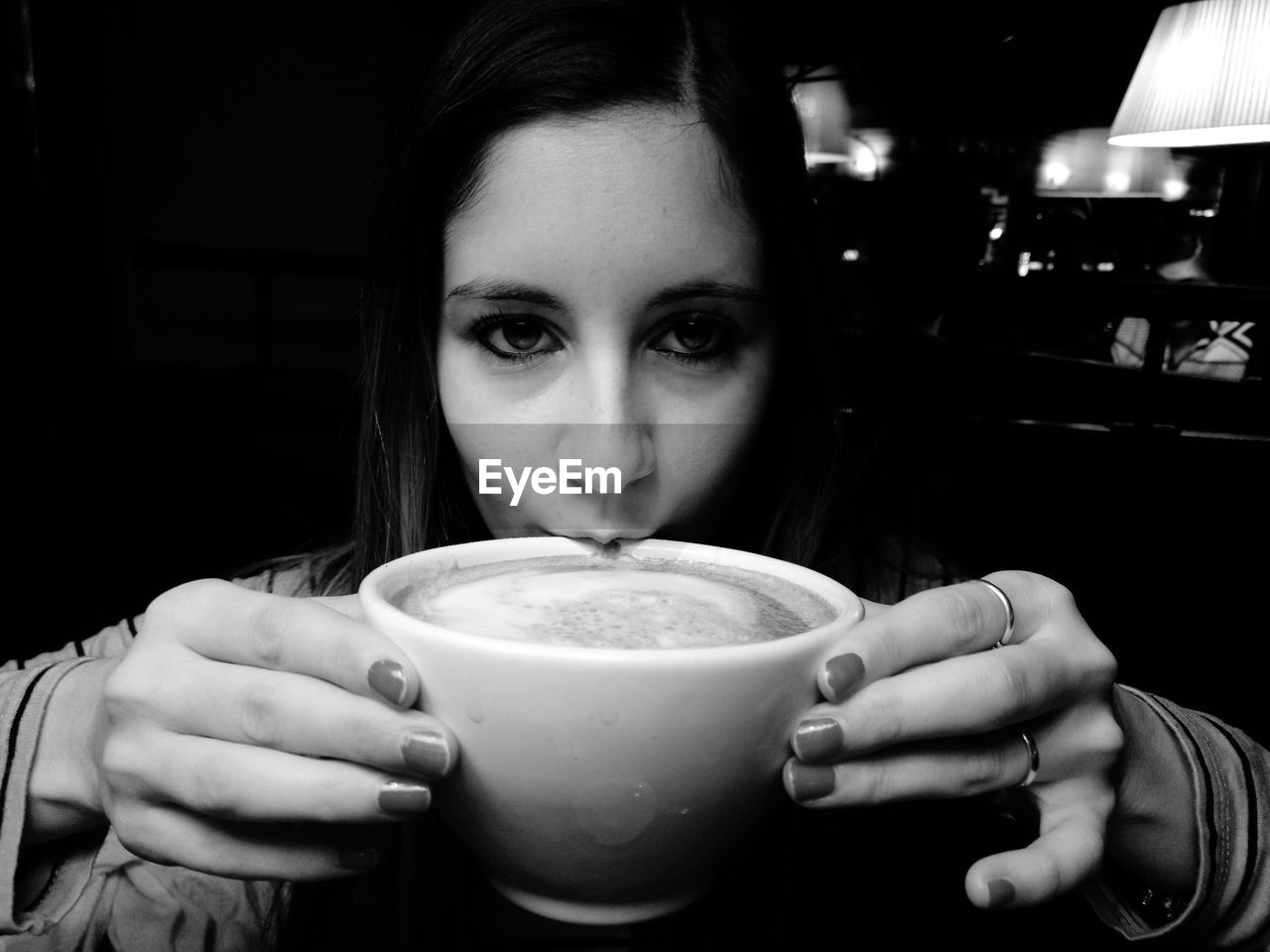 Close-up portrait of woman drinking coffee