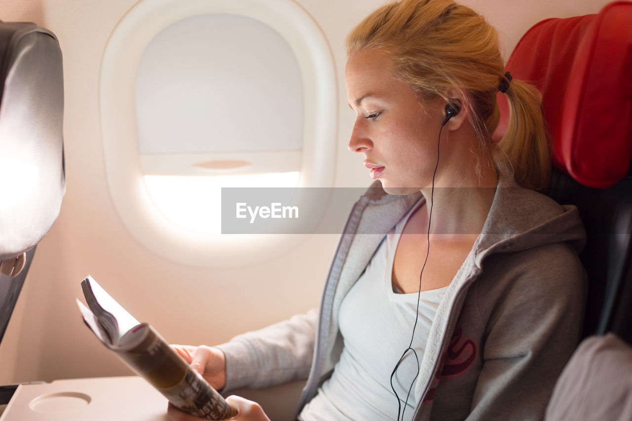 High angle view of businesswoman sitting in plane