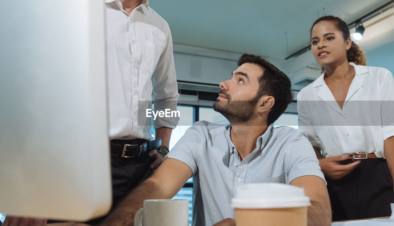 Business people discussing while sitting in office