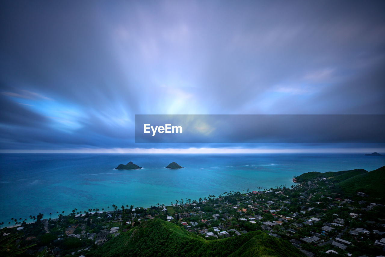 SCENIC VIEW OF SEA AGAINST SKY IN CITY