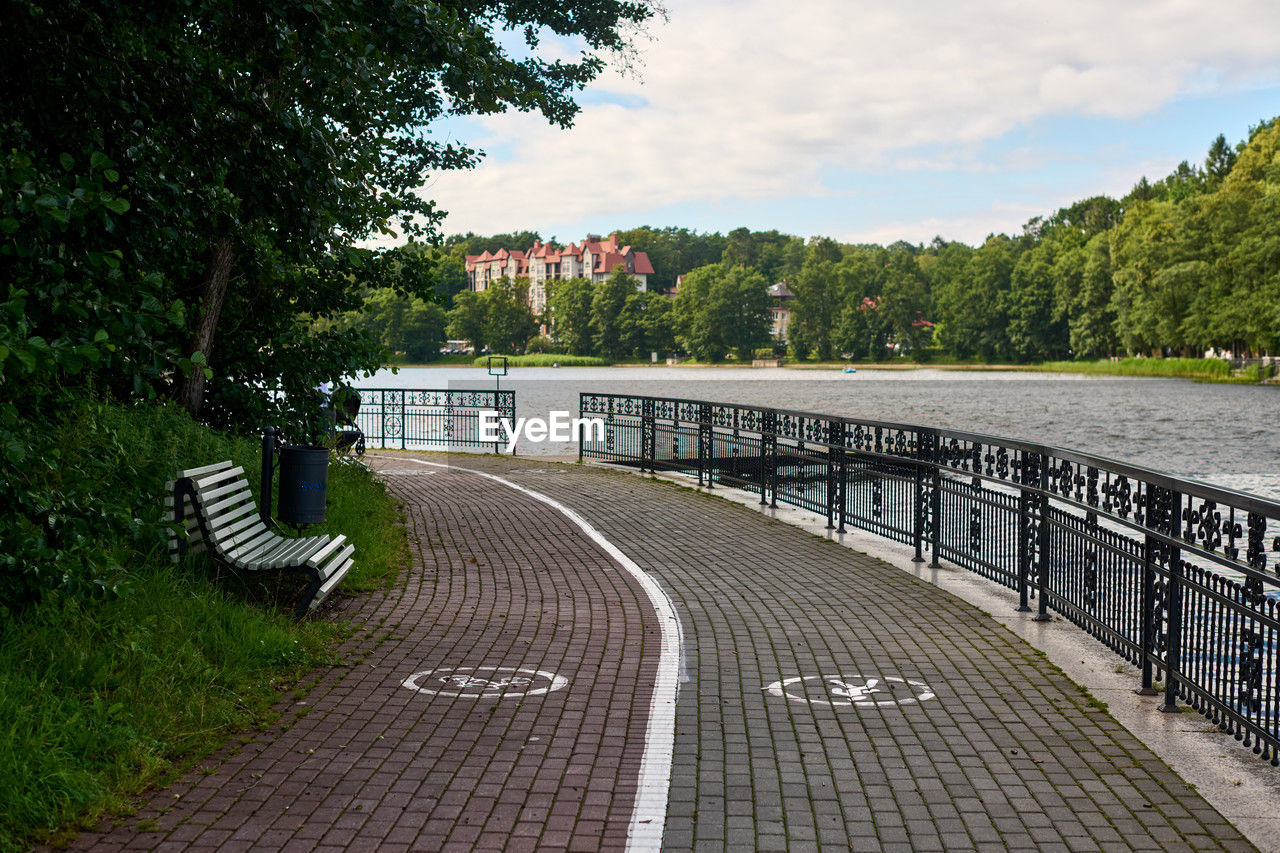 tree, walkway, plant, architecture, sky, nature, footpath, transportation, built structure, no people, railing, day, city, water, road, cloud, the way forward, bridge, outdoors, street, waterway, travel destinations, travel, tranquility, beauty in nature, symbol